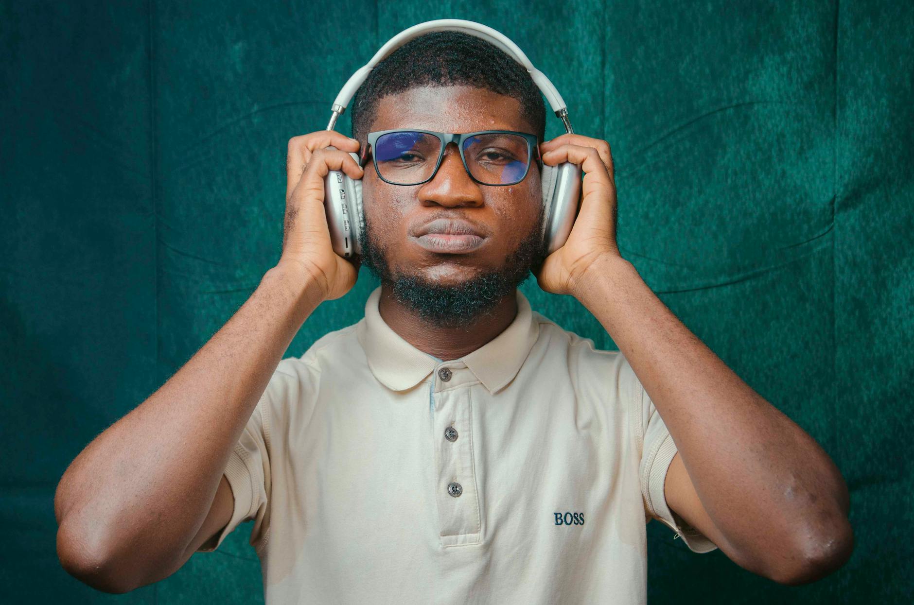 A young man with headphones enjoying music in a studio setting in Accra, Ghana.