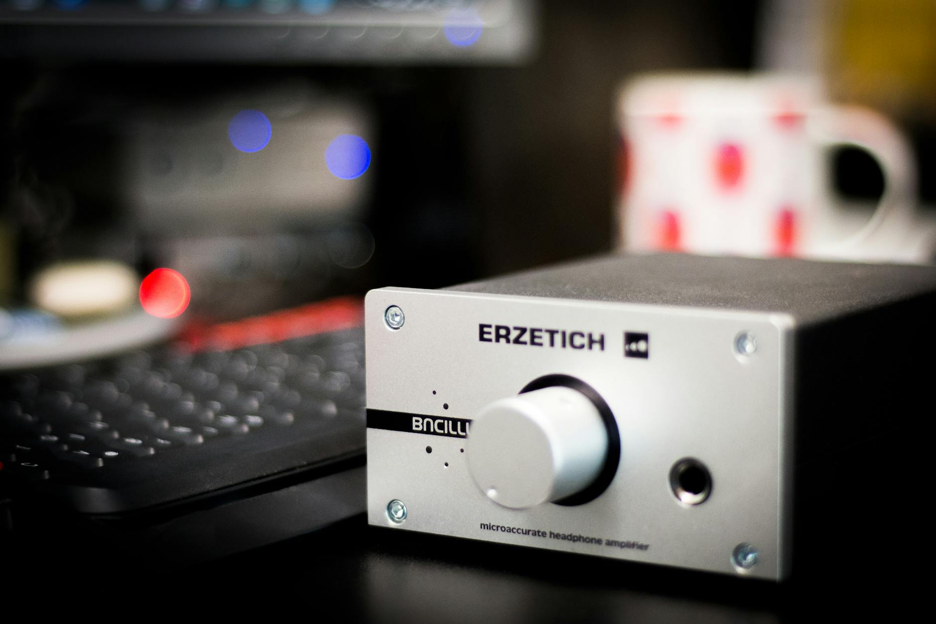 Close-up of a headphone amplifier in a studio setting, showcasing sleek design and advanced technology.